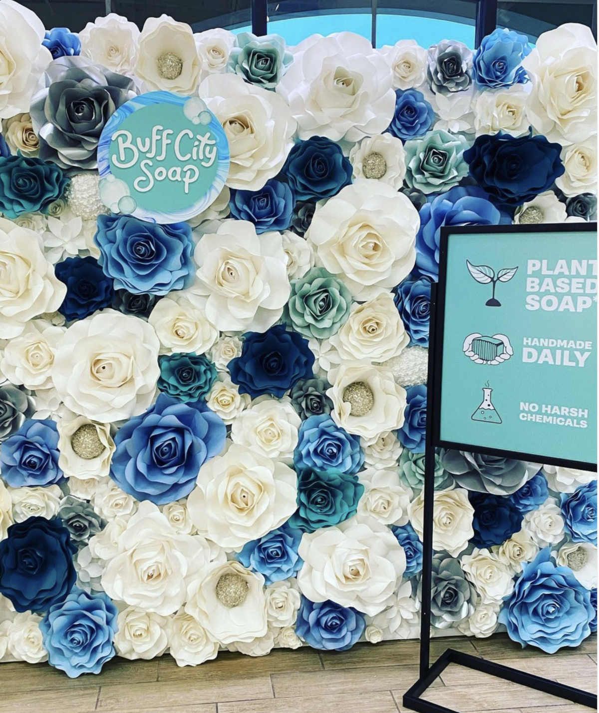 Blue branded flower wall for a soap brand event