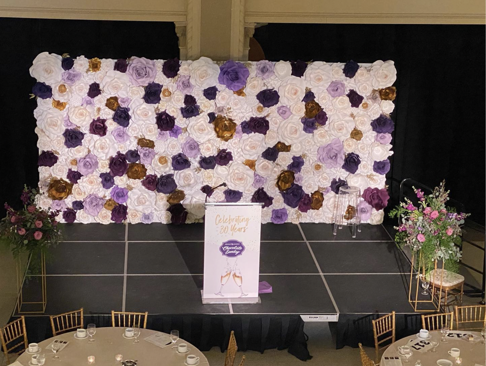 Large custom flower wall on a corporate event stage